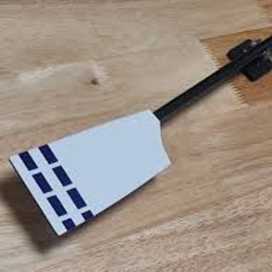 A rowing oar with its broad blade visible.