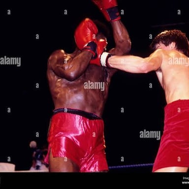 Two boxers facing each other in a ring, one throwing a quick straight punch.
