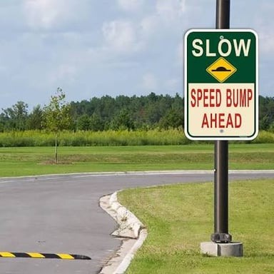Road signs displaying EXIT, STOP, SLOW, and BUMP.