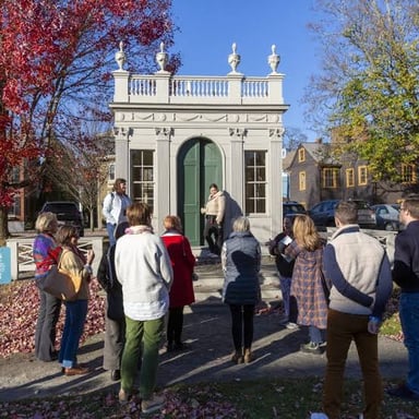 A group of sightseers on a guided tour at a city landmark.