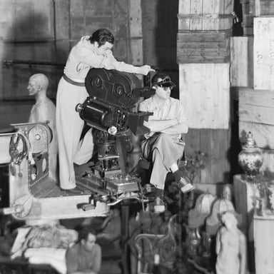 A film director overseeing actors and crew during a scene.