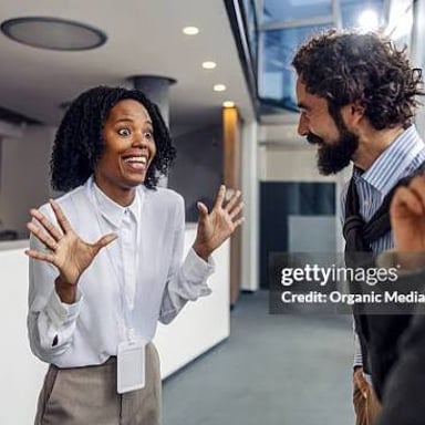 A person showing surprise while listening to someone.