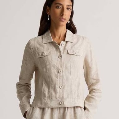 Flax plants beside linen fabric and a linen jacket.