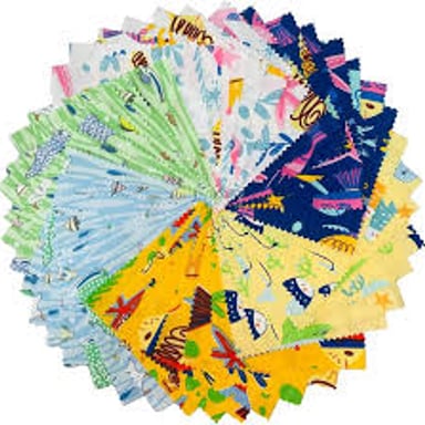 Fabric pieces cut into squares and arranged for quilting.