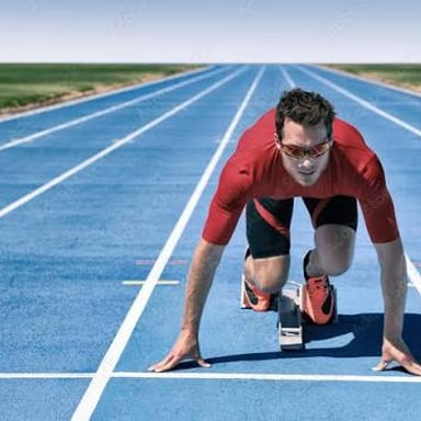 An athlete poised to start a race as the moment for action arrives