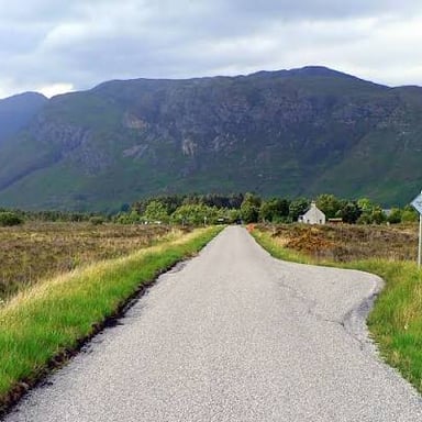 A narrow dirt road running through a rural landscape.