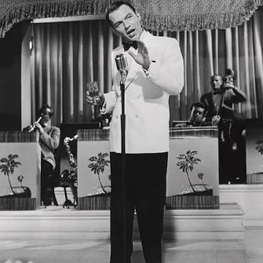 Singer Frank Sinatra performing with a microphone.