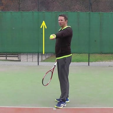 A person making a gentle toss of a ball.