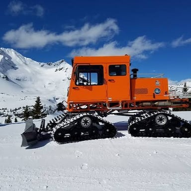A tracked Sno-Cat vehicle used on snow.