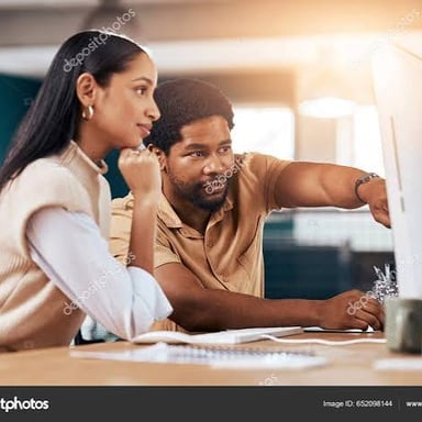 An assistant helping a coworker at a desk