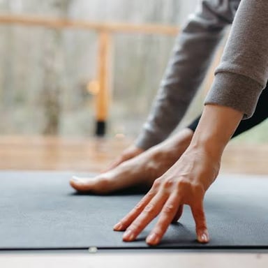 A person practicing yoga on a mat.