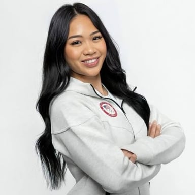 Olympic gymnast Suni Lee competing or posing with a gymnastics medal.