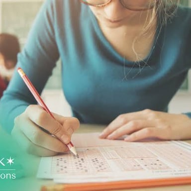 A student working on a standardized test at a desk.