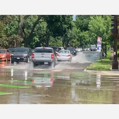 Rainwater floods a street, illustrating how one event can lead to another.