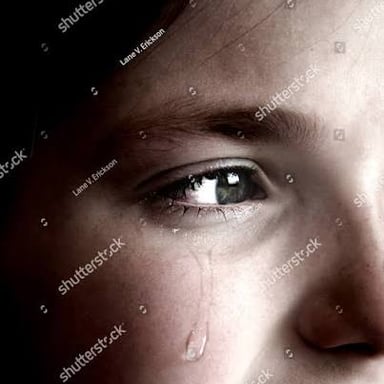 Tears on a person's cheek.