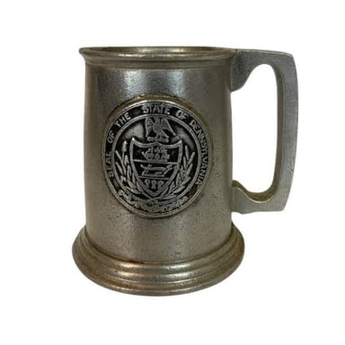 A silvery pewter tankard, made from an alloy whose main ingredient is tin.