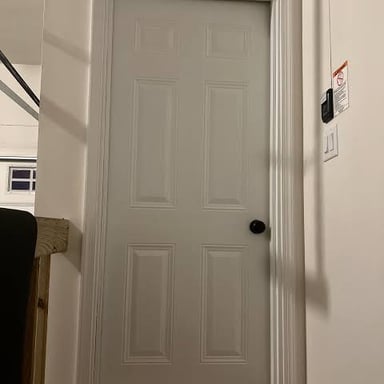 A damaged door pushed inward from a forceful impact.