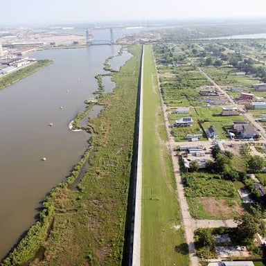A raised levee running alongside a river to help contain floodwater.