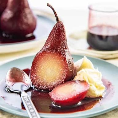 A pear gently poached and served as a dessert.