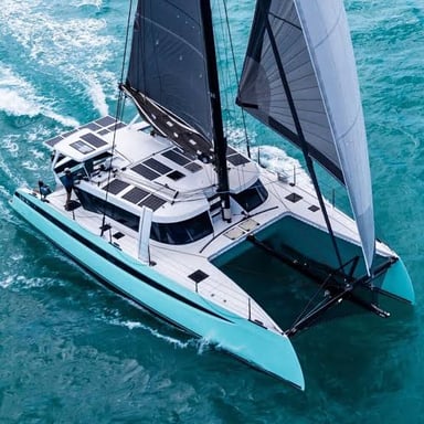 A catamaran traveling under sail.