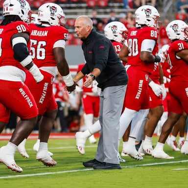 One sports team celebrating a win over its opponent.
