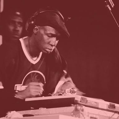 A DJ working turntables at a hip-hop performance.