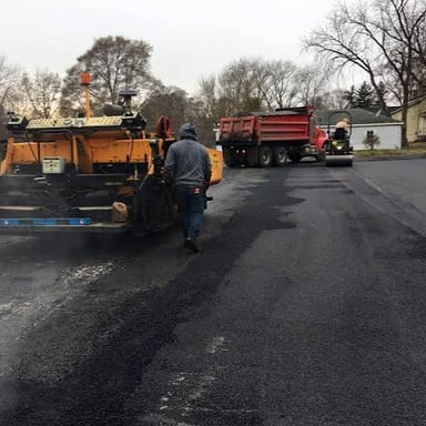 A paved parking lot with an asphalt surface.
