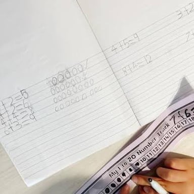 A person working an addition problem on paper.