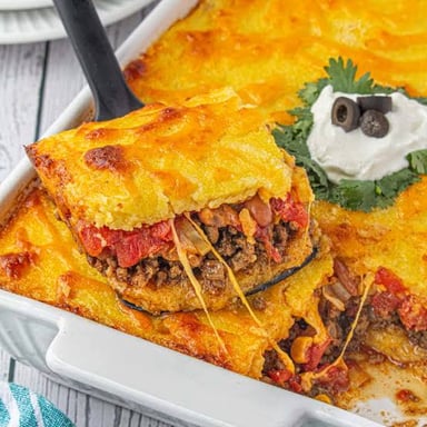 A baked tamale pie casserole with a cornmeal topping