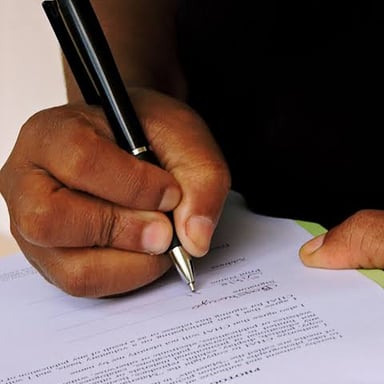 A person signing a document as the final step in an already settled matter.