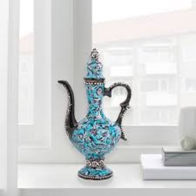 A decorative ewer, a handled pitcher with a spout for pouring.