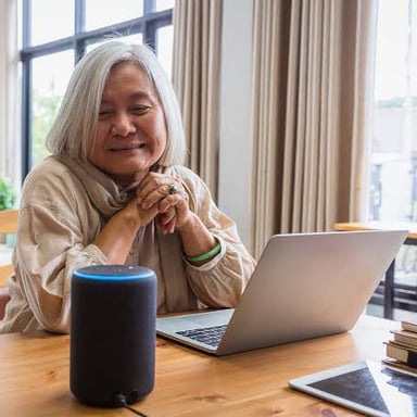 A person speaking a command to a smart speaker.