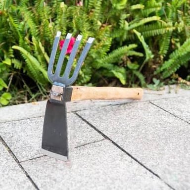 A garden hoe with a long handle and blade used for loosening soil and cutting weeds.