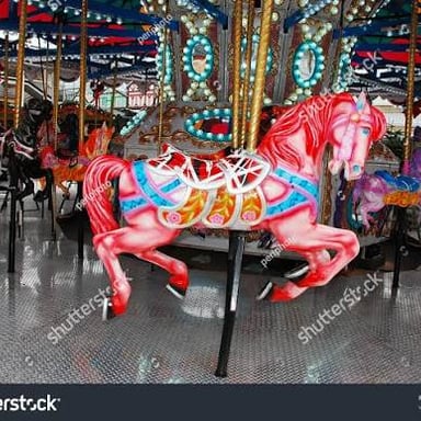 A merry-go-round with painted horses, evoking the jaunty music of a carousel.