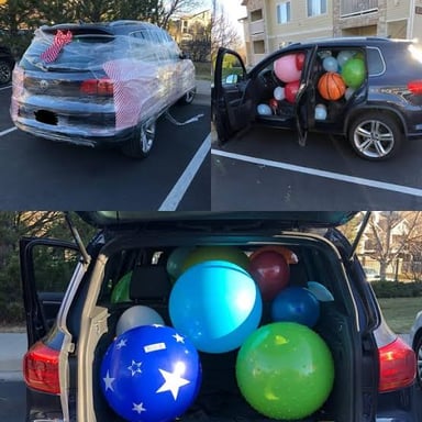A car interior filled with balloons as a playful prank.
