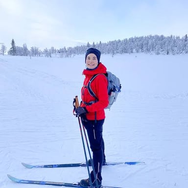 A skier using cross-country skis to travel across a snowy landscape.