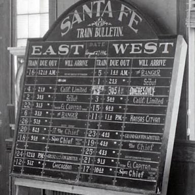 A railway arrival board showing a train scheduled to arrive.