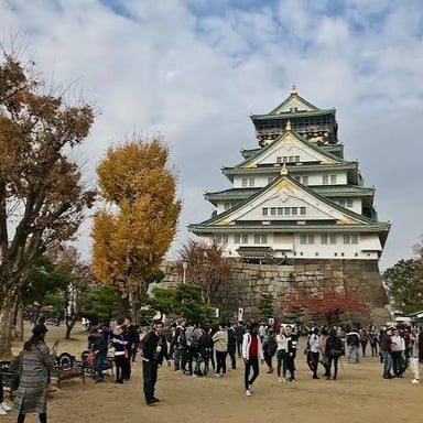 Osaka, a major Japanese city on Honshu, with Osaka Castle in the foreground.