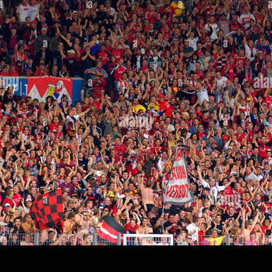 Organized football supporters gathered in stadium stands.