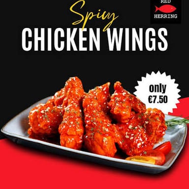 Chicken wings coated in a bright, spicy-looking sauce.