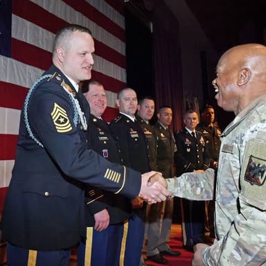 A lieutenant speaking with a sergeant, with the lieutenant holding the higher rank.