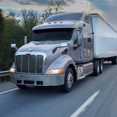 A tractor-trailer truck traveling on a highway.