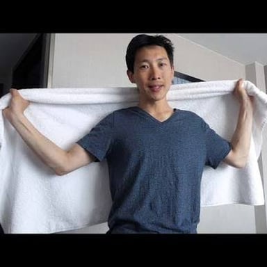 A person using a towel to dry off after swimming.