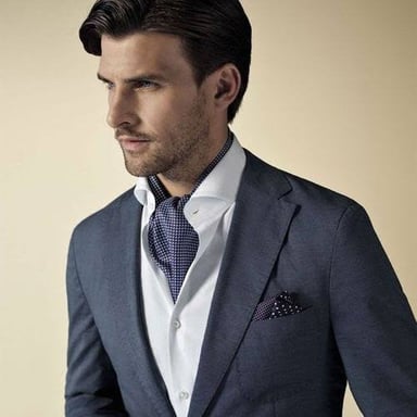 A conventional necktie alongside an ascot, a broader scarf-like style of neckwear.