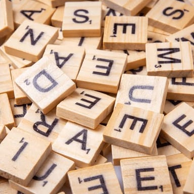 A Scrabble-style letter tile showing a one-point value.