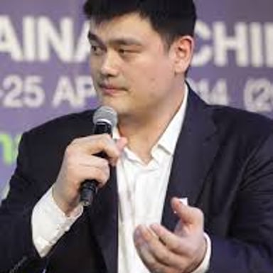 Basketball player Yao Ming standing on a court.