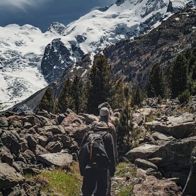 A hiker climbing upward on a mountain trail