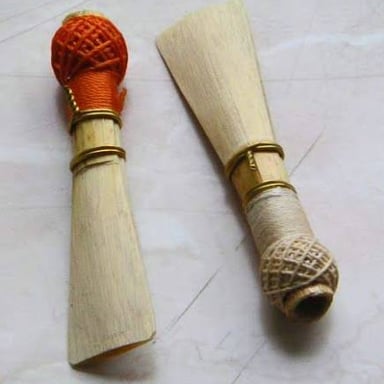 An oboe, a slender woodwind instrument with a flared bell and a double reed.
