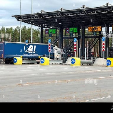 A truck approaching a toll plaza.
