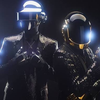 Daft Punk performing in their recognizable helmets.